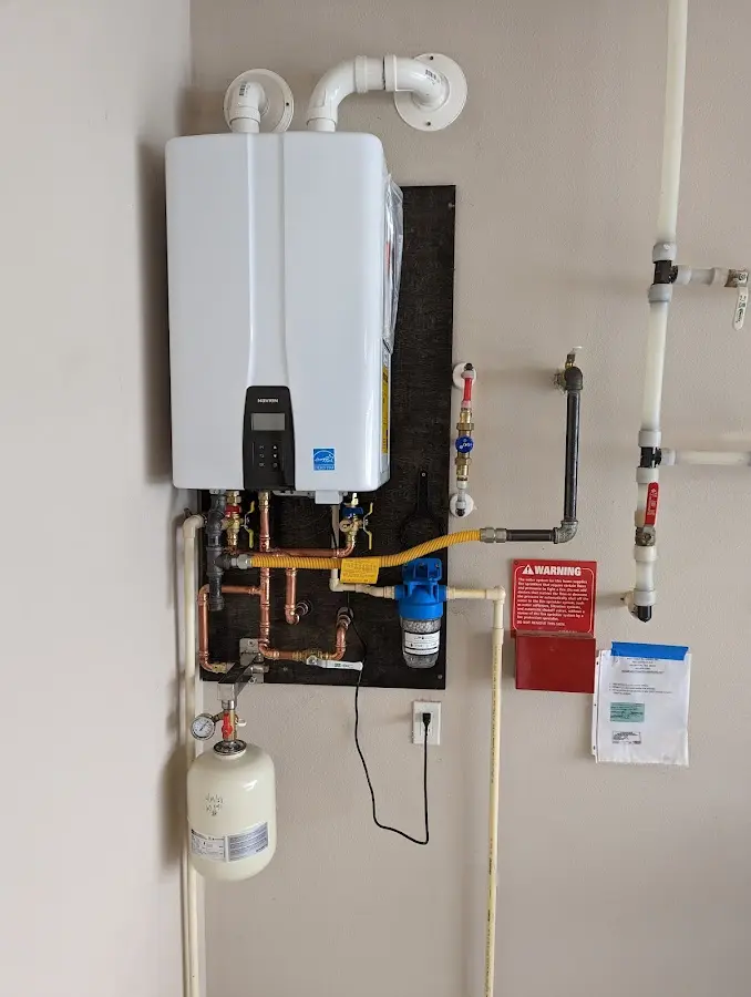 Professional plumber installing copper piping in a Cozad home